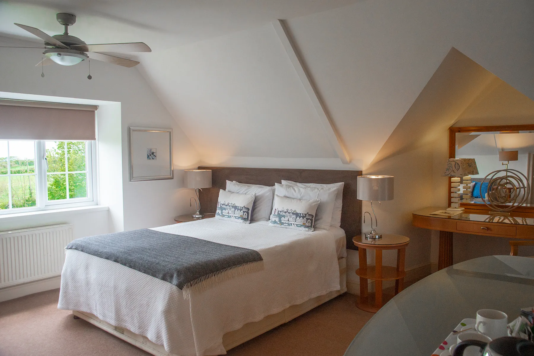Room 6, a large contemporary king-size room on the second floor at Higher Faugan Parc, with ceiling fan and garden views