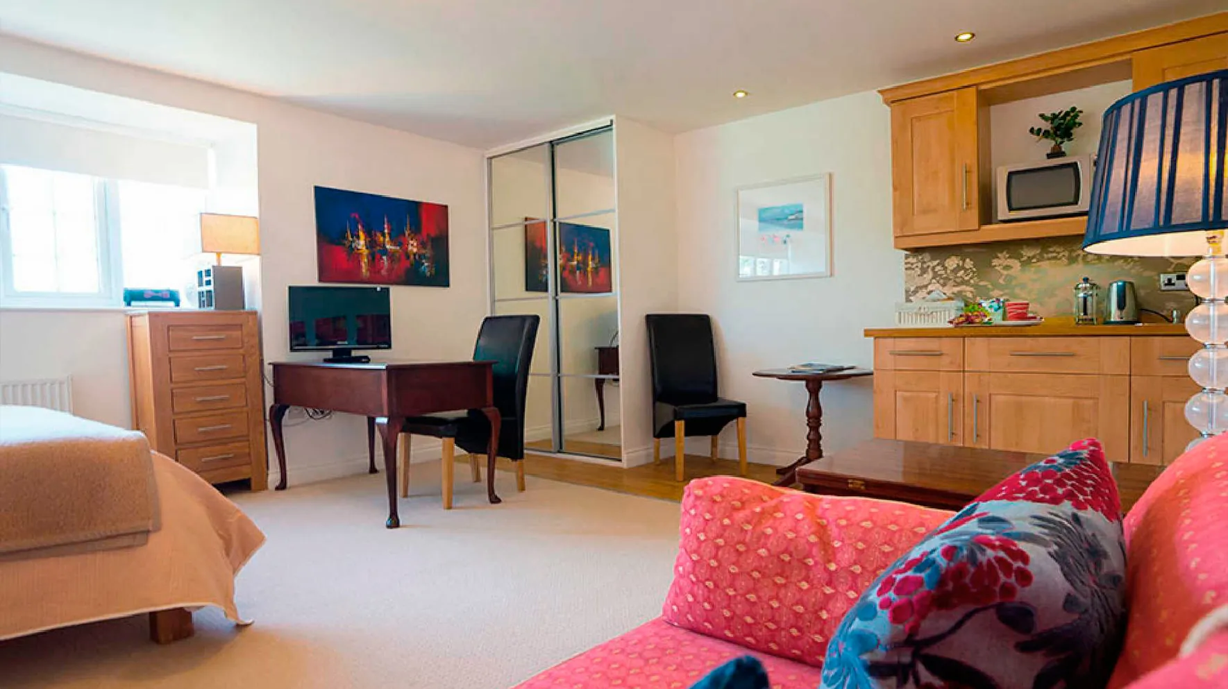 Room 1 at Higher Faugan Parc: desk, mirror and kitchen area
