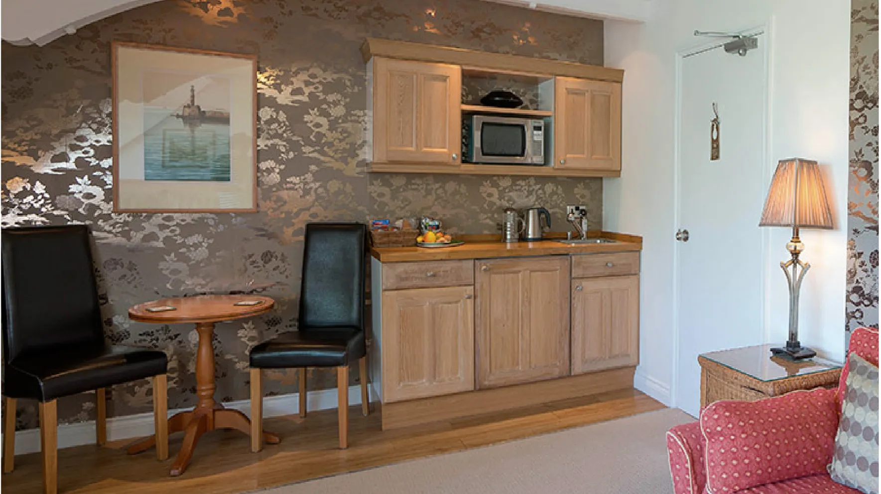 Room 3 at Higher Faugan Parc: the kitchen area with microwave, kettle and dining table
