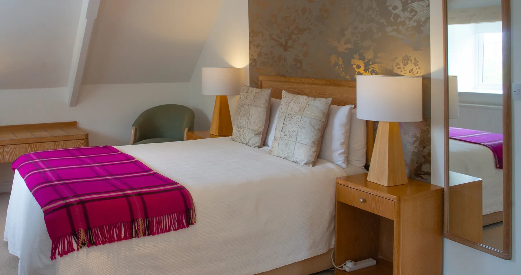 Room 4 at Higher Faugan Parc: bed under the eaves with bedside lamps