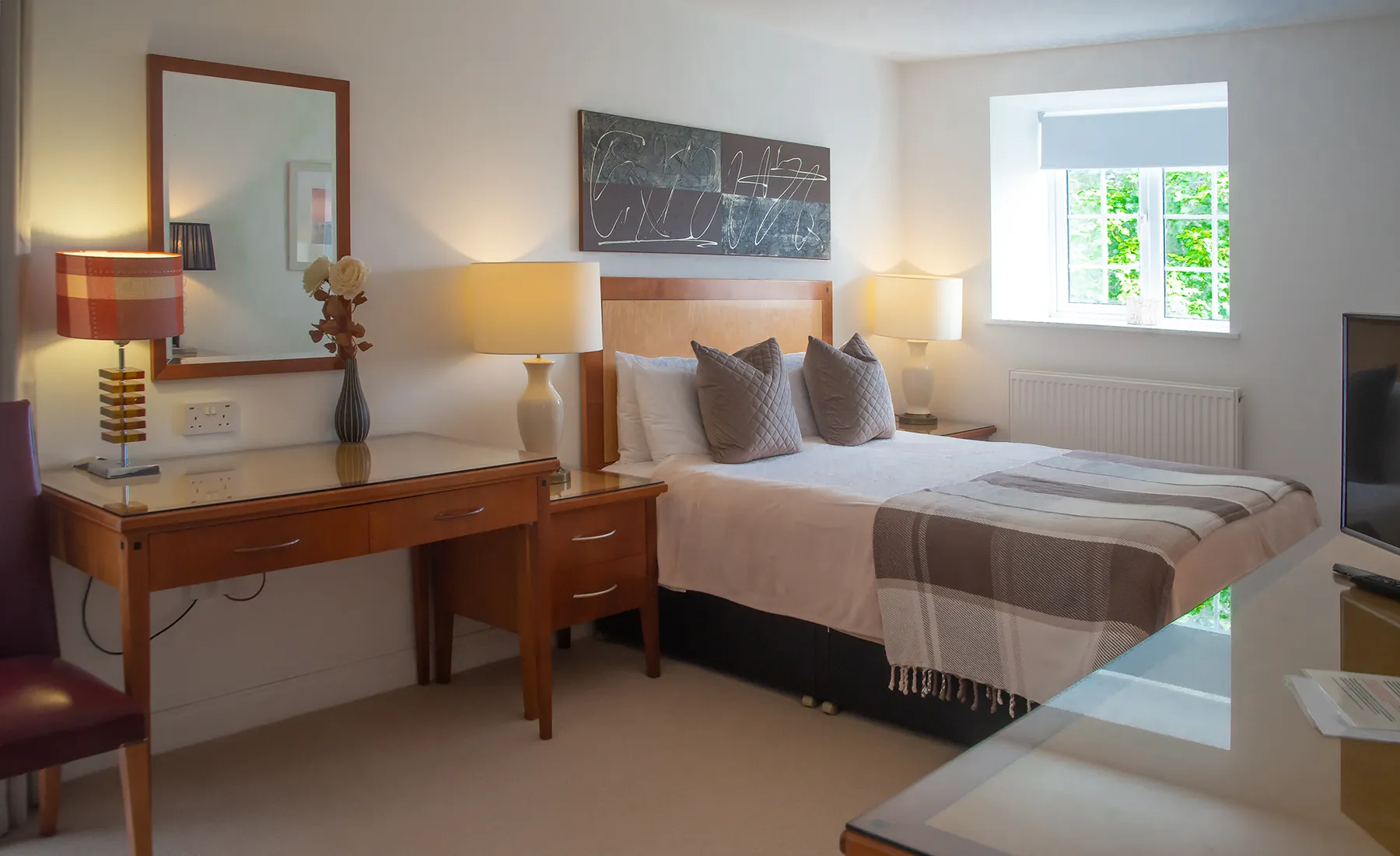 Room 2, a ground-floor luxury suite at Higher Faugan Parc, with king-size bed and woodland outlook