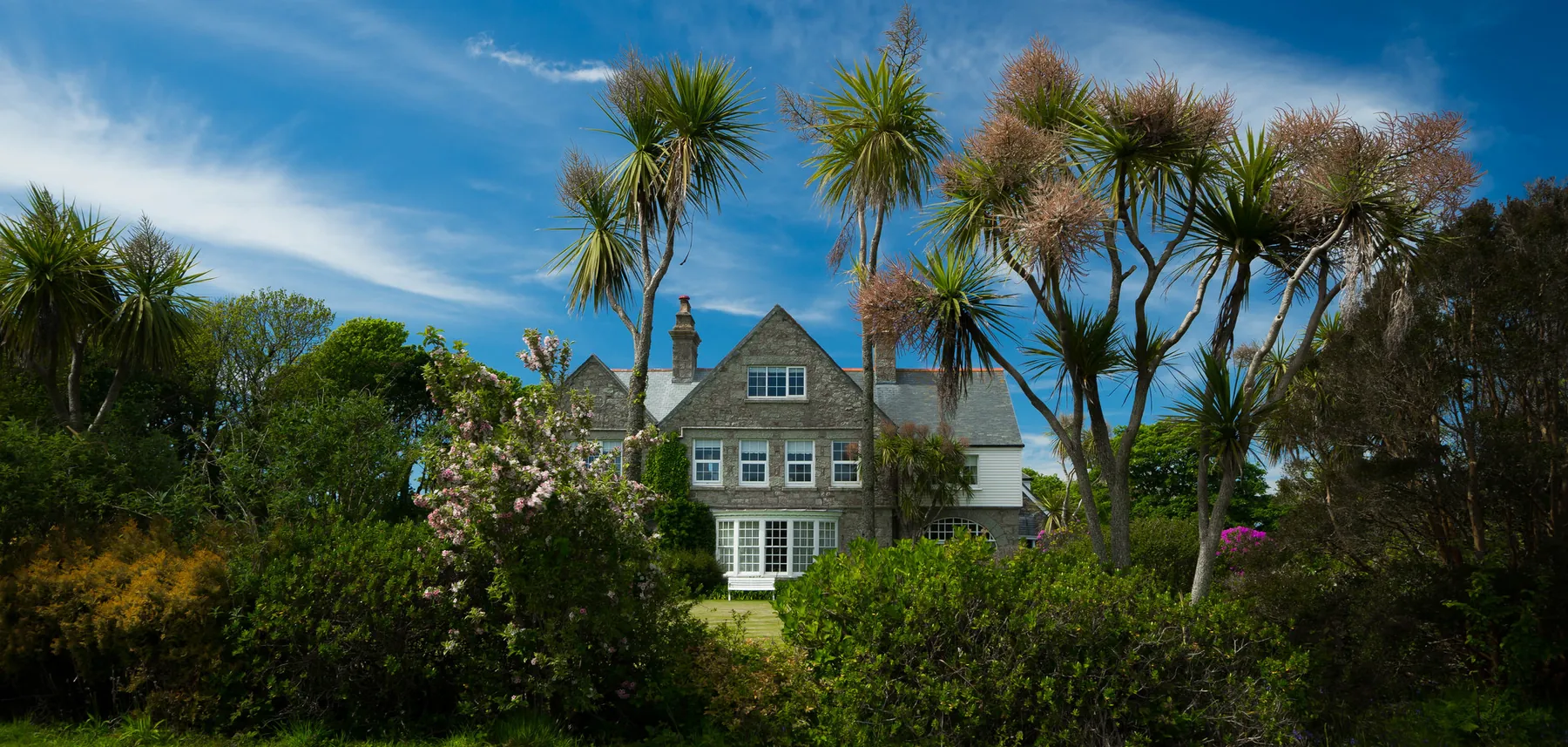 The gabled front elevation of Higher Faugan Parc above the private grounds at Newlyn