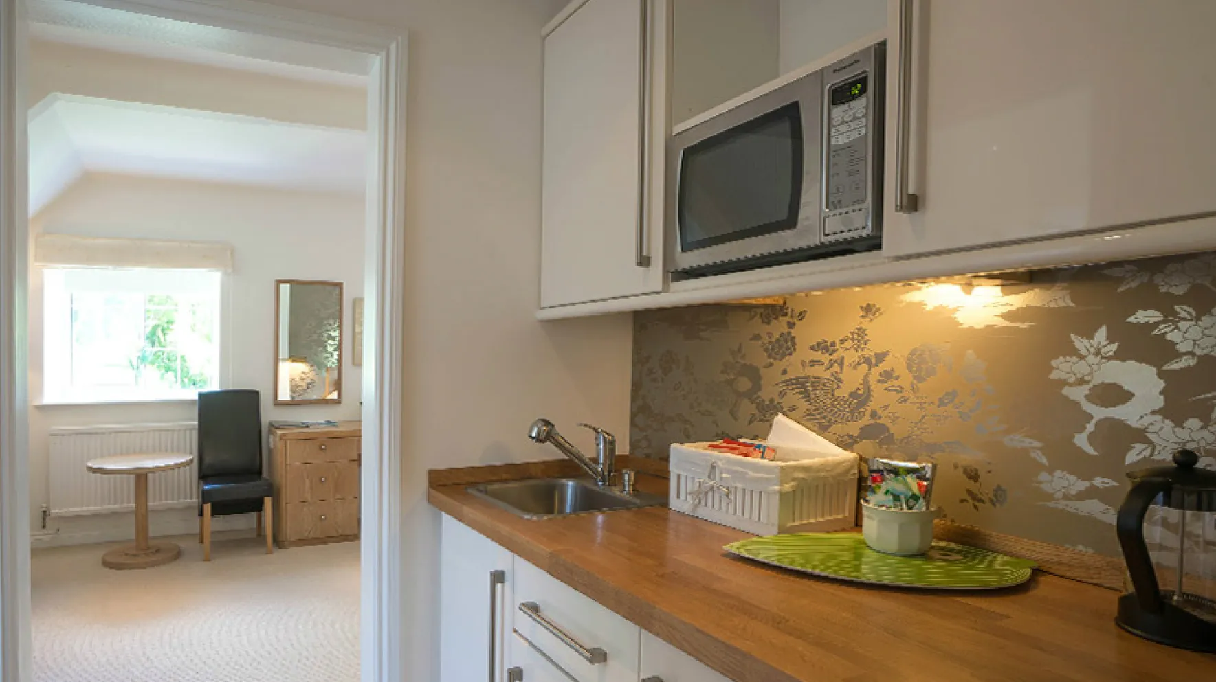 Room 4 at Higher Faugan Parc: the kitchen area with sink, microwave and kettle
