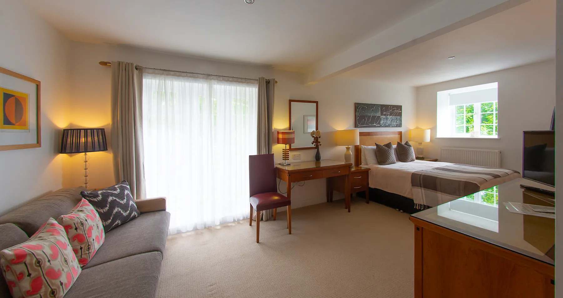 Room 2 at Higher Faugan Parc: sofa, desk and television within the suite
