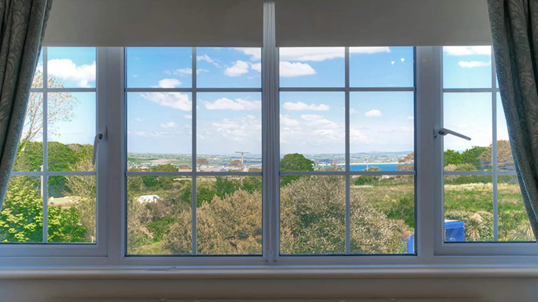 The view over the gardens toward Penzance and Mount's Bay from Room 7 at Higher Faugan Parc