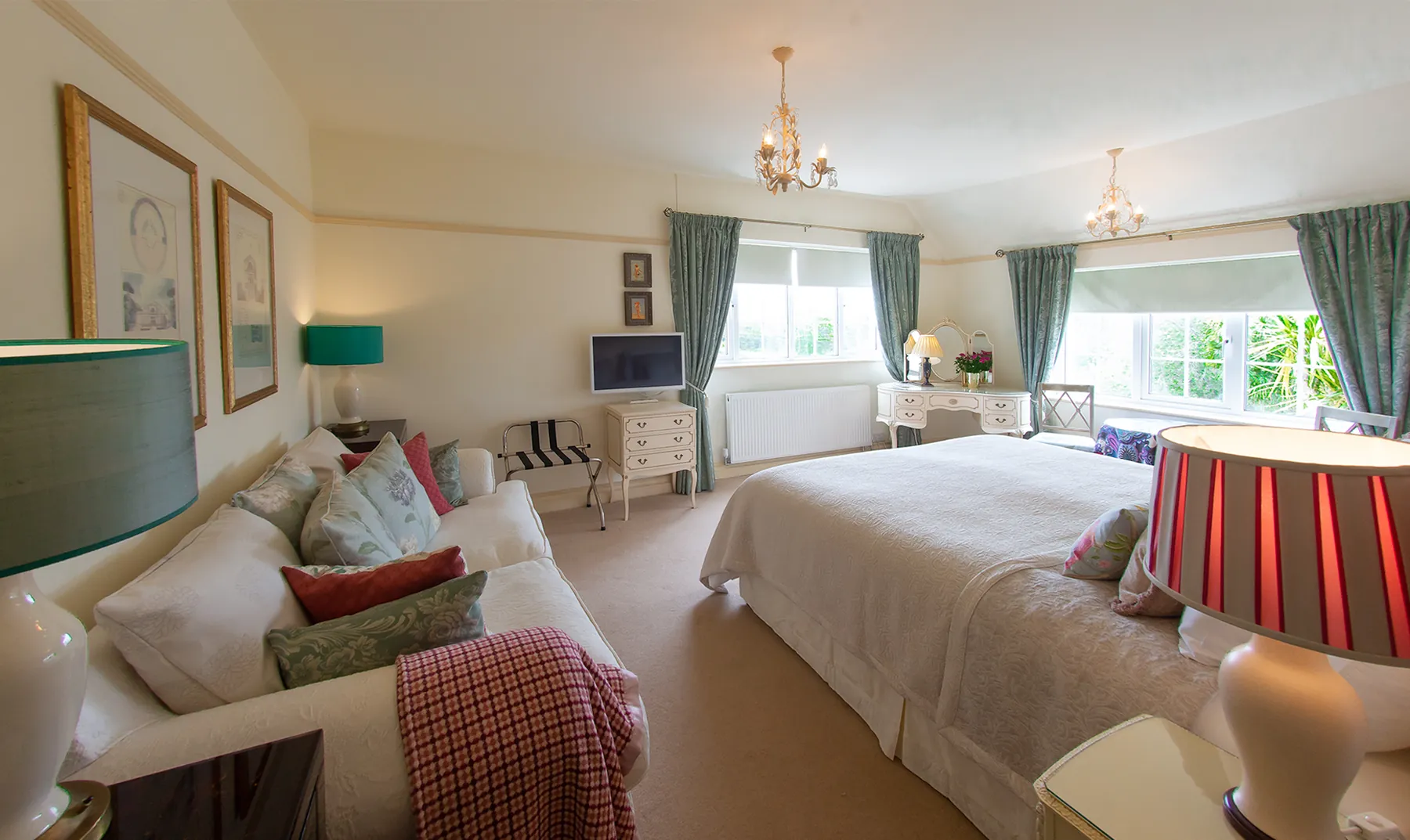 Room 7, a superior king-size room at Higher Faugan Parc, with sofa, chandelier and garden views